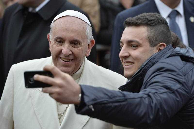 Pope Francis poses for a selfie as he arrives at the San Giuseppe all'Aurelio parish for a pastoral visit on December 14, 2014 in Rome. Pope Francis poses for a selfie as he arrives at the San Giuseppe all'Aurelio parish for a pastoral visit on December 14, 2014 in Rome.
