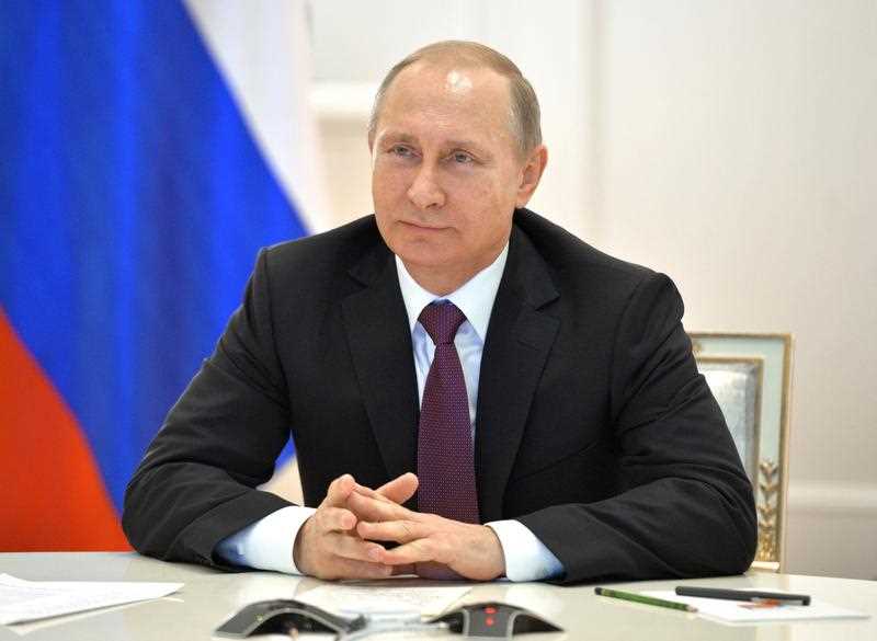 Russian President Vladimir Putin smiles during a live video link with members of Russian Geographical Society expedition to the Southern Pole in Moscow's Kremlin, Russia on Friday, Dec. 26, 2014. Russian President Vladimir Putin smiles during a live video link with members of Russian Geographical Society expedition to the Southern Pole in Moscow's Kremlin, Russia on Friday, Dec. 26, 2014.