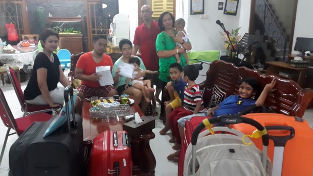 Lucky escape: Christianawati, her husband Ari Putro Cahyono and their extended family after missing flight QZ8501. Lucky escape: Christianawati, her husband Ari Putro Cahyono and their extended family after missing flight QZ8501.