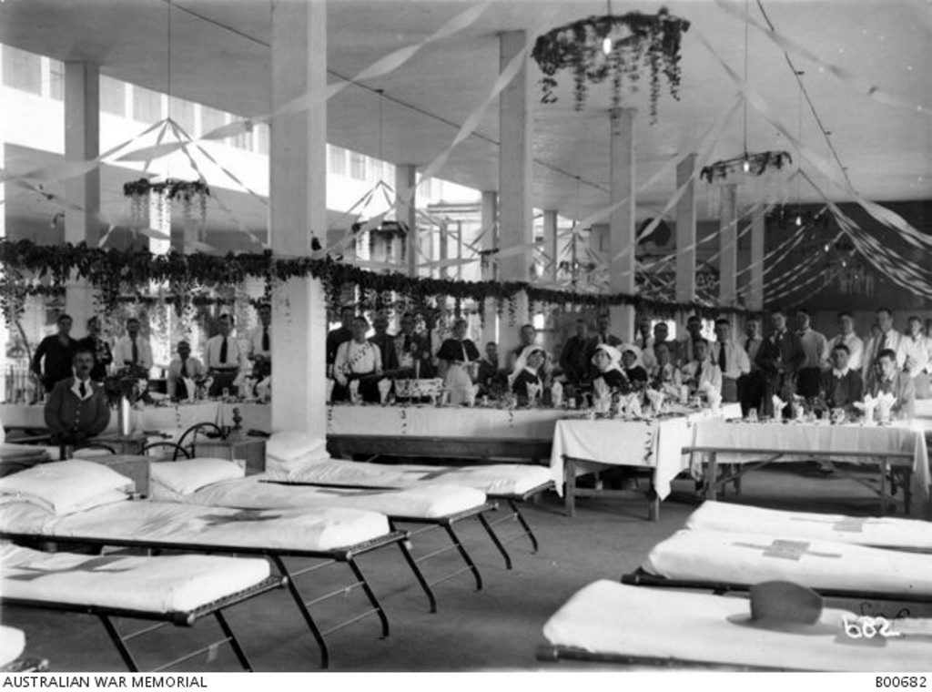 Staff and patients at No 14 Australian General Hospital, Egypt, decorated for Christmas in 1918. In the background, tables are set for Christmas dinner. Courtesy of Australian War Memorial B00682 Staff and patients at No 14 Australian General Hospital, Egypt, decorated for Christmas in 1918. In the background, tables are set for Christmas dinner. Courtesy of Australian War Memorial B00682