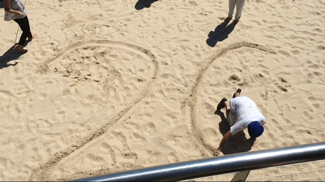 Sunshine Coast Daily Property Editor Erle Levey draws the all-important 2015 on Mooloolaba beach Sunshine Coast Daily Property Editor Erle Levey draws the all-important 2015 on Mooloolaba beach