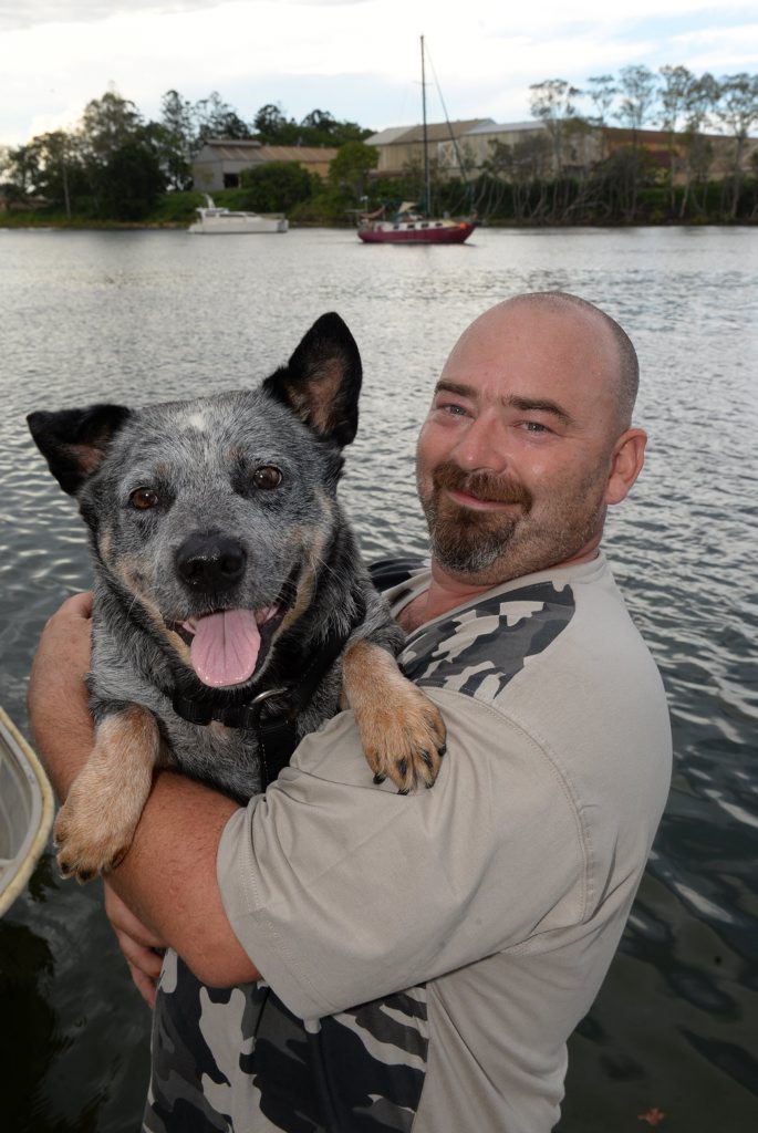 BEST FRIENDS: Mark Huggy Hughes and his dog Shiela with their yacht Vardos moored in the background on the Burnett River. Photo: Mike Knott / NewsMail BEST FRIENDS: Mark Huggy Hughes and his dog Shiela with their yacht Vardos moored in the background on the Burnett River. Photo: Mike Knott / NewsMail