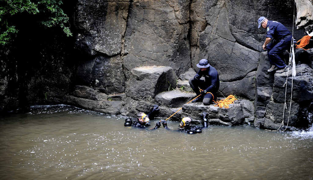 TRAGEDY: Police divers search the waterhole at Hanging Rock Falls for the body of a 19-year-old Sydney man who had been swimming with a group of friends. TRAGEDY: Police divers search the waterhole at Hanging Rock Falls for the body of a 19-year-old Sydney man who had been swimming with a group of friends.