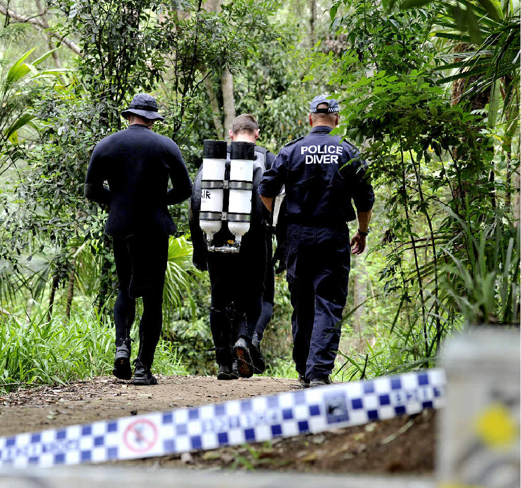 Police walk down the path to the Hanging Rock Falls rock pool. Police walk down the path to the Hanging Rock Falls rock pool.