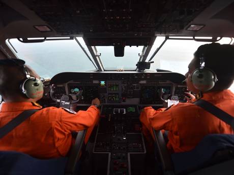 Pilot and co-pilot of the Indonesian air force keep a look out during search and rescue operations for the missing AirAsia flight QZ8501 Pilot and co-pilot of the Indonesian air force keep a look out during search and rescue operations for the missing AirAsia flight QZ8501