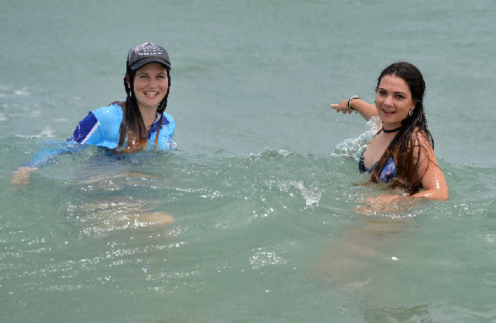 SWIM UNDER SUPERVISION: Sisters Karrie and Ashleigh Hayward feel safer swimming at Harbour Beach, where life savers regularly drag for marine stingers and patrol the beach. SWIM UNDER SUPERVISION: Sisters Karrie and Ashleigh Hayward feel safer swimming at Harbour Beach, where life savers regularly drag for marine stingers and patrol the beach.