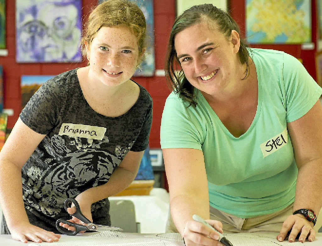 CREATIVE: Brianna Bruce, 12, and promotions co-ordinator Kristel Kelly working hard to prep tiles to be used for a mosaic. CREATIVE: Brianna Bruce, 12, and promotions co-ordinator Kristel Kelly working hard to prep tiles to be used for a mosaic.
