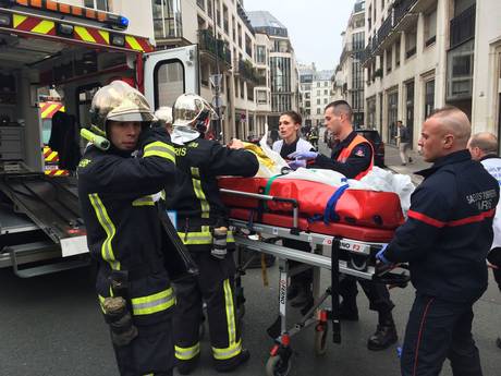 Firefighters carry an injured man on a stretcher in front of the offices of the French satirical newspaper Charlie Hebdo in Paris Firefighters carry an injured man on a stretcher in front of the offices of the French satirical newspaper Charlie Hebdo in Paris