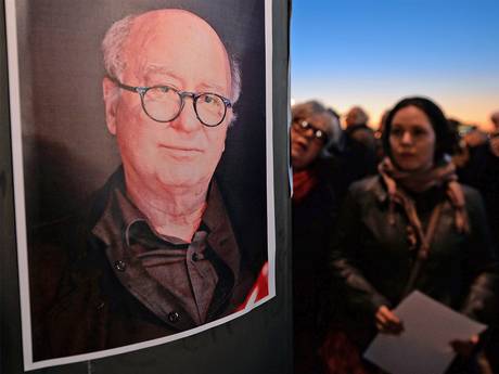 People stand stand in Marseille, southern France, next to a portrait of French cartoonist Georges Wolinksi, killed during an attack by unknown gunmen on the offices of the satirical weekly, 'Charlie Hebdo' People stand stand in Marseille, southern France, next to a portrait of French cartoonist Georges Wolinksi, killed during an attack by unknown gunmen on the offices of the satirical weekly, 'Charlie Hebdo'