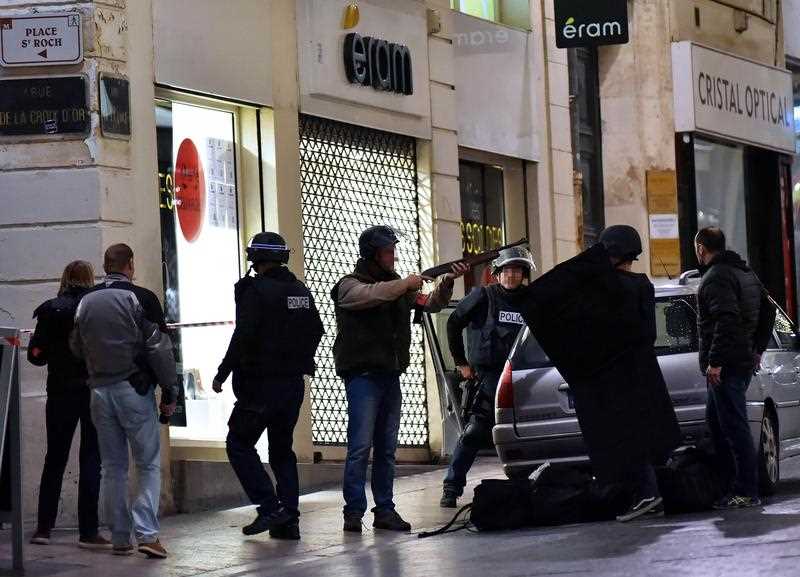 A police officer takes aim with a rifle next to others a outside a jewellery store where two people are being held hostage by a gunman attempting a robbery. A police officer takes aim with a rifle next to others a outside a jewellery store where two people are being held hostage by a gunman attempting a robbery.
