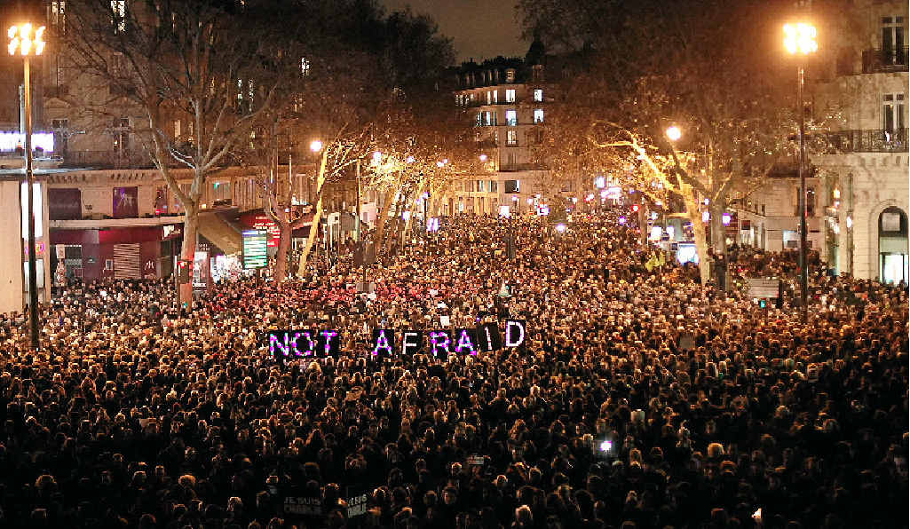 DEFIANCE SYMBOL: People gather in Paris to pay respect to those murdered at Charlie Hebdo. DEFIANCE SYMBOL: People gather in Paris to pay respect to those murdered at Charlie Hebdo.