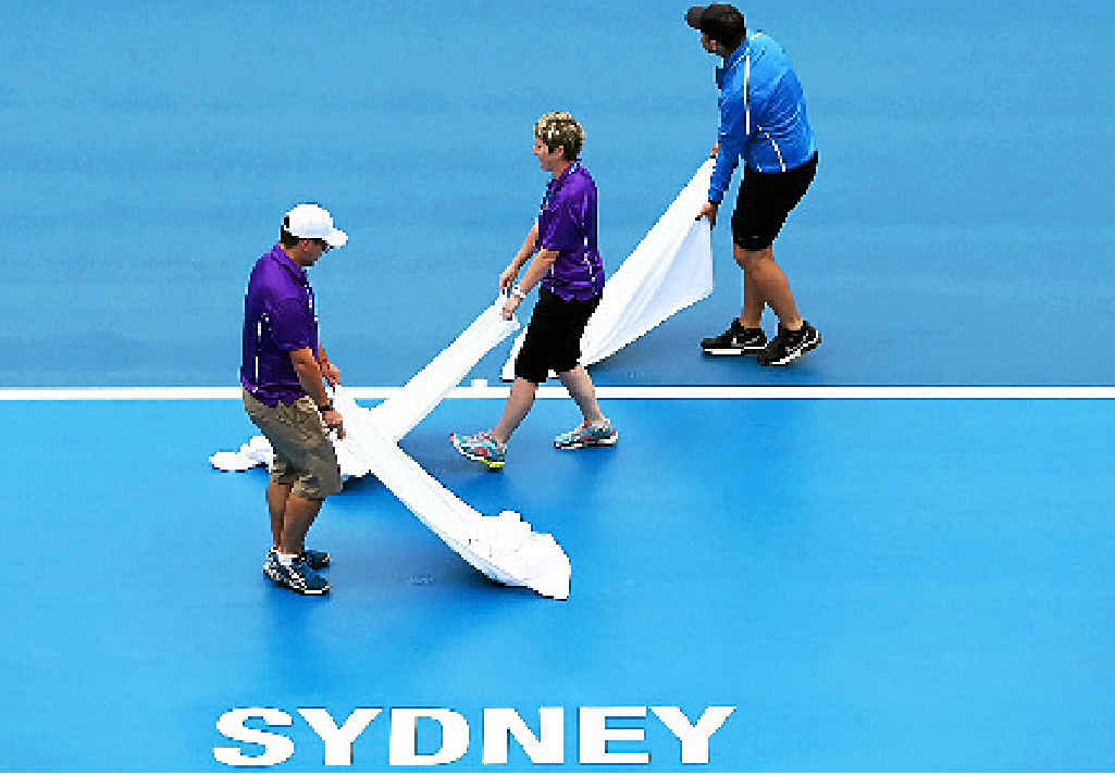 MOPPING UP: Ground staff dry the courts after persistent rain during the day one of the 2015 Sydney International. MOPPING UP: Ground staff dry the courts after persistent rain during the day one of the 2015 Sydney International.