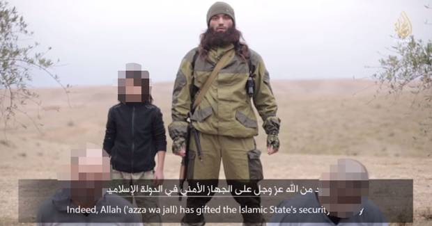 An ISIS propaganda video purports to show a boy, believed to be aged about 10, killing two 'Russian spies' An ISIS propaganda video purports to show a boy, believed to be aged about 10, killing two 'Russian spies'
