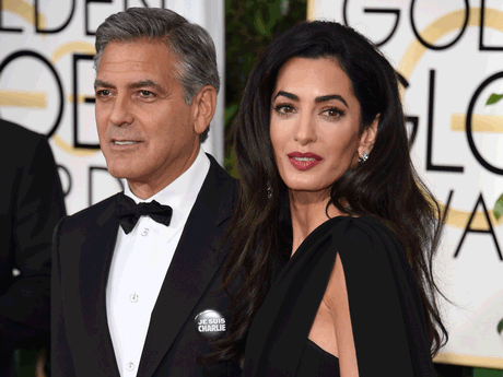 George Clooney wearing a 'Je suis Charlie' badge with his wife, Amal. George Clooney wearing a 'Je suis Charlie' badge with his wife, Amal.