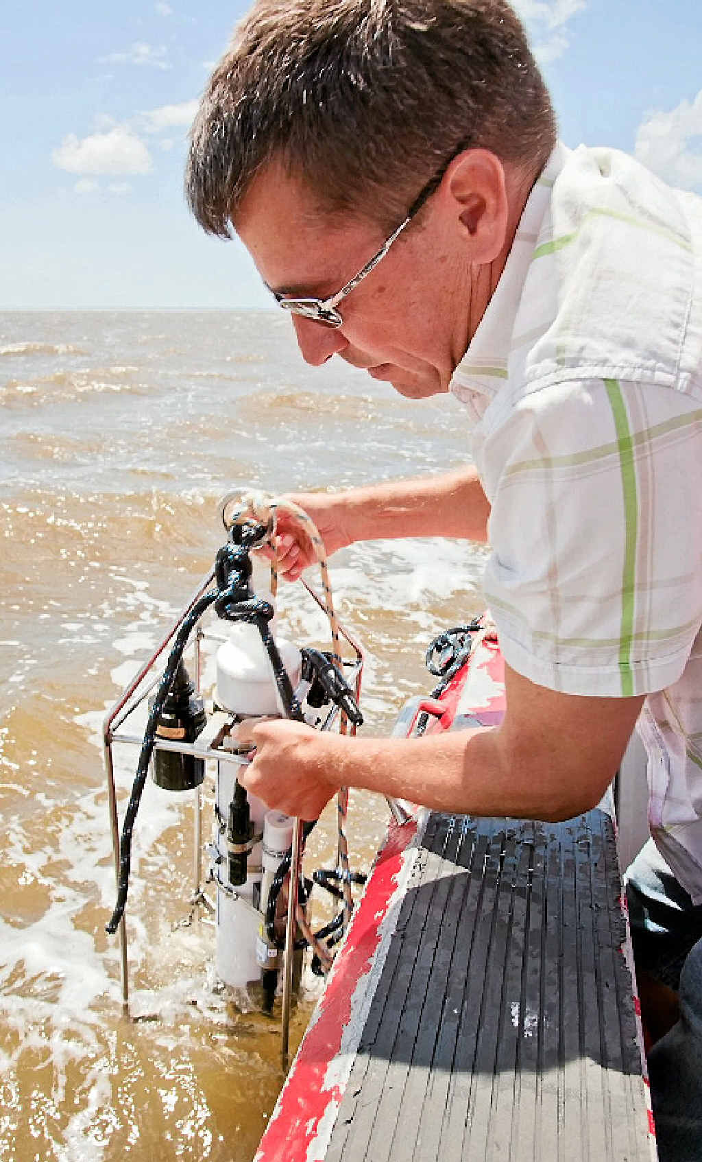University of Southern Queensland associate professor Joachim Ribbe lowers research equipment into water near Fraser Island. University of Southern Queensland associate professor Joachim Ribbe lowers research equipment into water near Fraser Island.