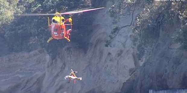 The Westpac Trust Rescue Helicopter winches Stewart Rundle to safety following his call for help from the bottom of the cliff. Picture / One News The Westpac Trust Rescue Helicopter winches Stewart Rundle to safety following his call for help from the bottom of the cliff. Picture / One News