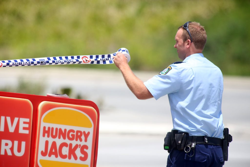 Police Officer containing the area where an armed robbery occurred at a Tweed Heads South petrol station. Photo: Nolan Verheij-Full / Tweed Daily News Police Officer containing the area where an armed robbery occurred at a Tweed Heads South petrol station. Photo: Nolan Verheij-Full / Tweed Daily News