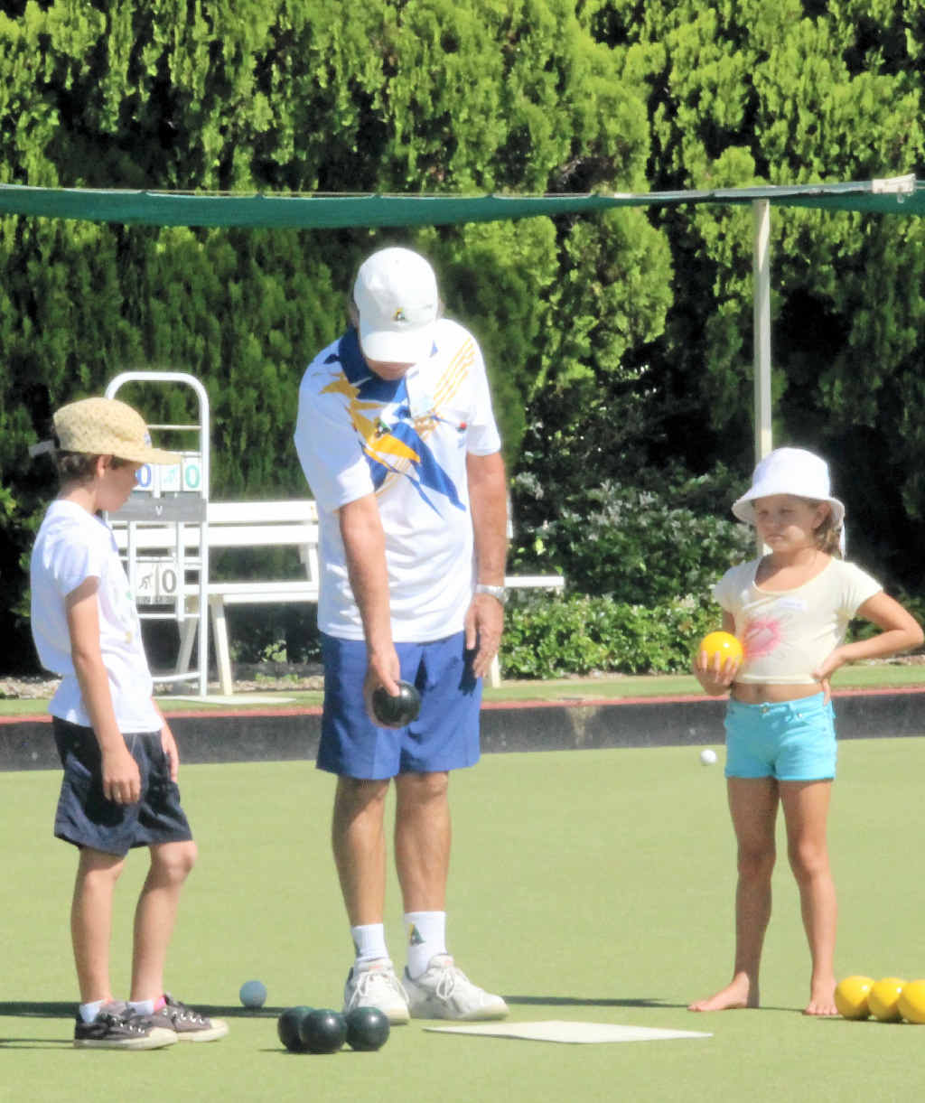 BOWLS FUN: Club coach Pete Stephan teaches young bowlers Simon Dwyer and Georgina Drysdale some new tricks. BOWLS FUN: Club coach Pete Stephan teaches young bowlers Simon Dwyer and Georgina Drysdale some new tricks.