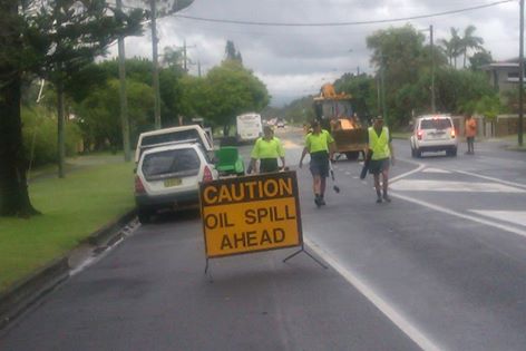 Workers cleaning up an oil spill at Shirley Street, Byron Bay. Workers cleaning up an oil spill at Shirley Street, Byron Bay.