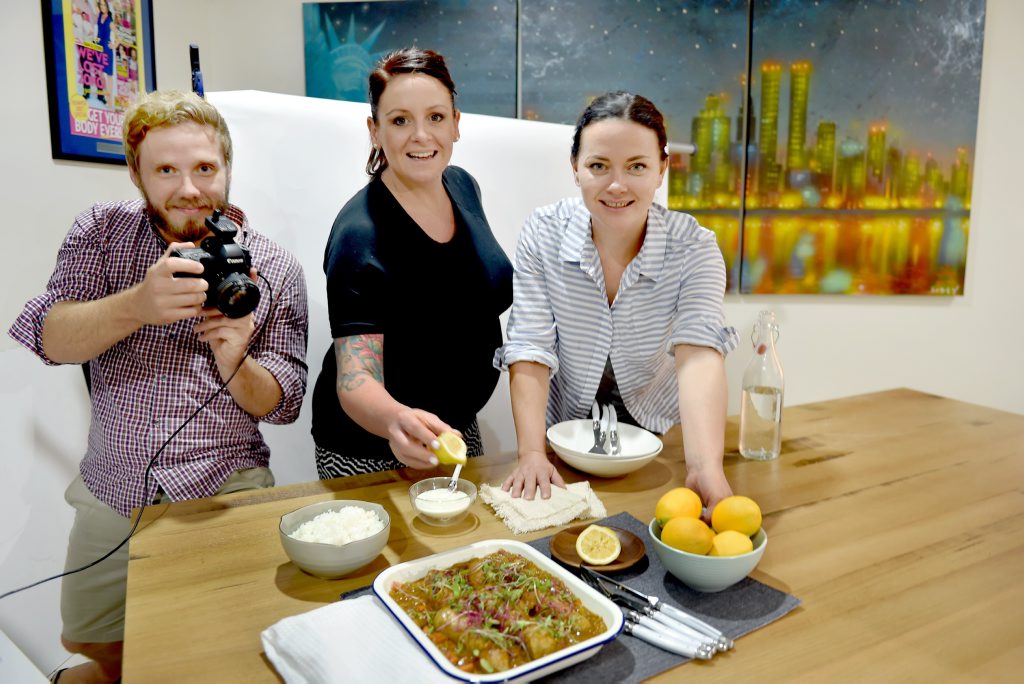 Photographer Glen Wilson, Steph Mulheron and food stylist Krista Graham with a sausage curry being photographed for Eat Meat Sweet. Photographer Glen Wilson, Steph Mulheron and food stylist Krista Graham with a sausage curry being photographed for Eat Meat Sweet.