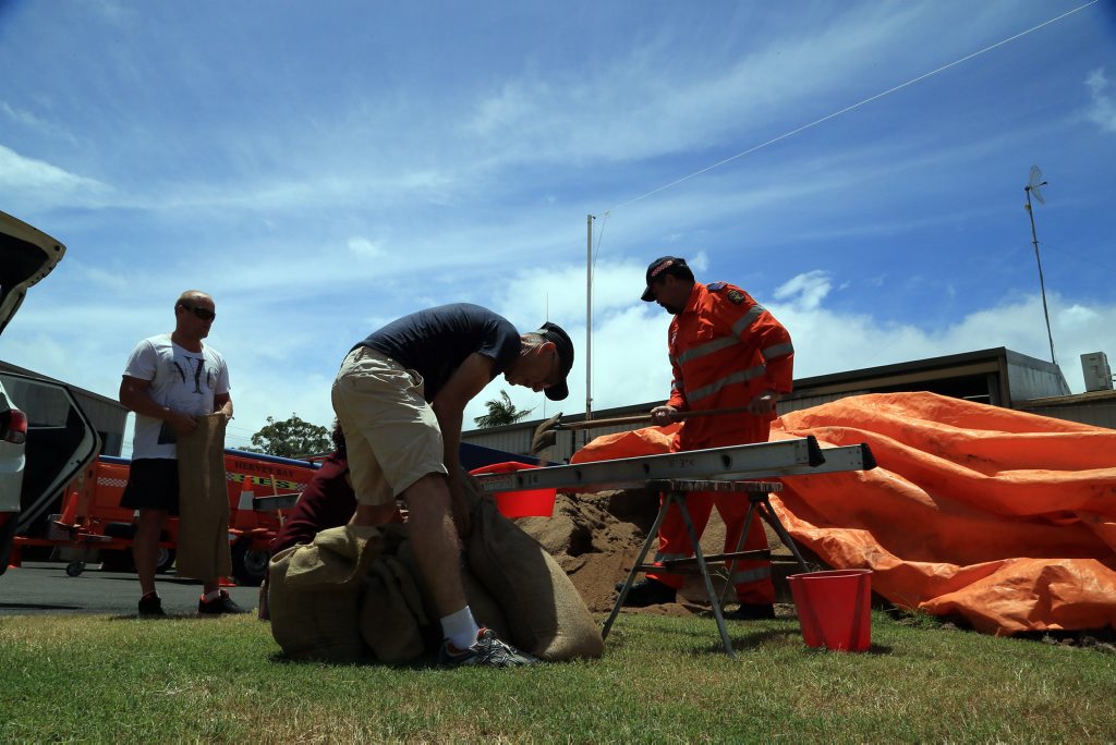 SES member Corey Waynwright (right) filling sandbags for concerned residents in Hervey Bay. SES member Corey Waynwright (right) filling sandbags for concerned residents in Hervey Bay.