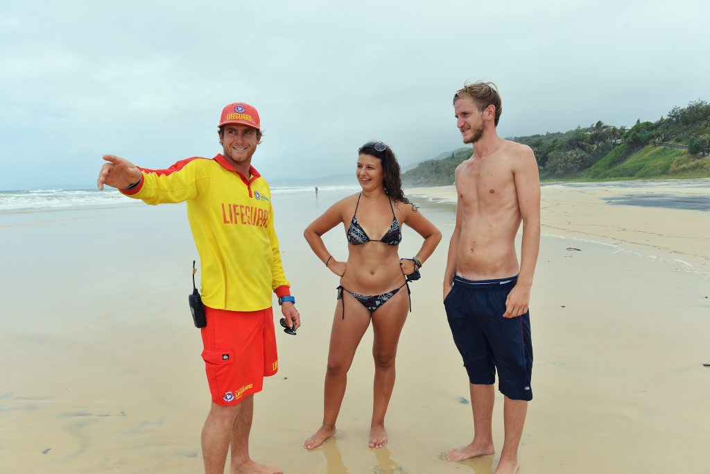 Out enjoying the beautiful day before the storm. From left Australian Lifegurad Service, Rainbow Beach lifeguard Ben Davis talks with German backpackers, Maria Pilz and Chris Naegele about beach conditions at Rainbow Beach. Photo: Greg Miller / Gympie Times Out enjoying the beautiful day before the storm. From left Australian Lifegurad Service, Rainbow Beach lifeguard Ben Davis talks with German backpackers, Maria Pilz and Chris Naegele about beach conditions at Rainbow Beach. Photo: Greg Miller / Gympie Times