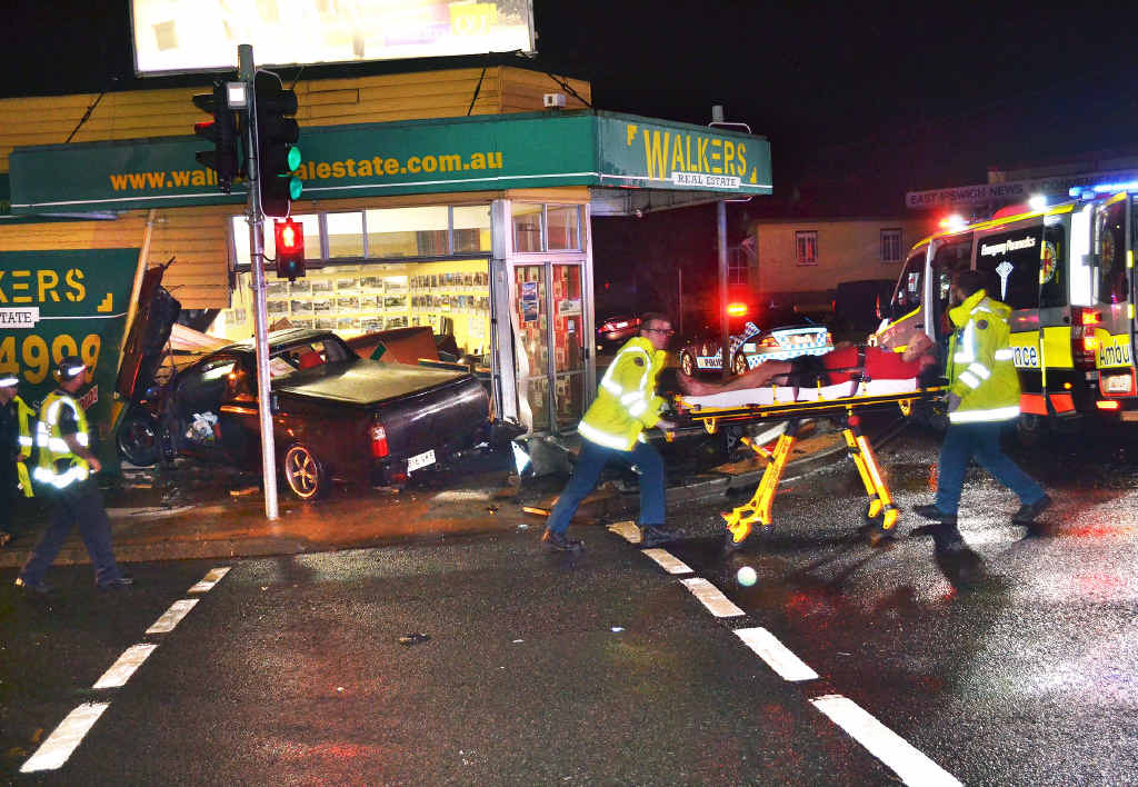 DRIVE IN: The driver of the car that crashed through the front of Walkers Real Estate is taken from the scene by paramedics. The crash at the five-ways in Ipswich occurred at 10pm on Thursday night. DRIVE IN: The driver of the car that crashed through the front of Walkers Real Estate is taken from the scene by paramedics. The crash at the five-ways in Ipswich occurred at 10pm on Thursday night.