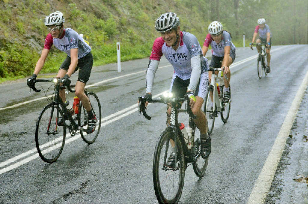 OVER THE TOP: Riders pedal through the rain after reaching the summit of the Jackagery Gap climb during the 228km Grafton To Inverell Cyclo Sportif on Saturday. PHOTO: BILL NORTH OVER THE TOP: Riders pedal through the rain after reaching the summit of the Jackagery Gap climb during the 228km Grafton To Inverell Cyclo Sportif on Saturday. PHOTO: BILL NORTH