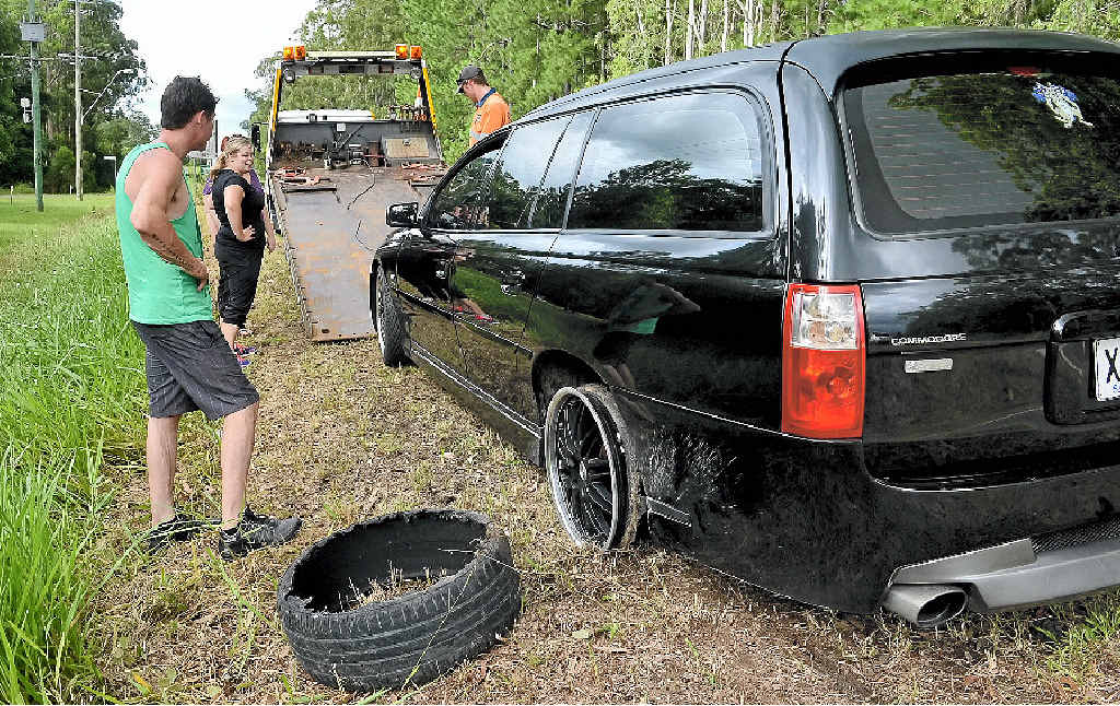 TYRE TROUBLE: Natasha Griffin (inset) blew a tyre when she hit a pothole on Steve Irwin Way. ABOVE: A car busted a wheel a few hundred metres away yesterday. TYRE TROUBLE: Natasha Griffin (inset) blew a tyre when she hit a pothole on Steve Irwin Way. ABOVE: A car busted a wheel a few hundred metres away yesterday.
