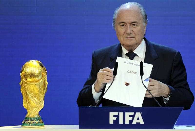 FIFA President Sepp Blatter holding up the name of Qatar during the official announcement of the 2022 World Cup host country at the FIFA headquarters in Zurich. FIFA President Sepp Blatter holding up the name of Qatar during the official announcement of the 2022 World Cup host country at the FIFA headquarters in Zurich.