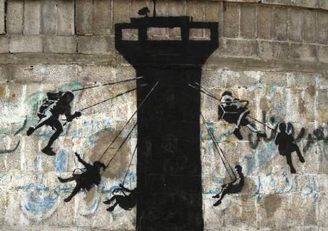 A Banksy stencil of children enjoying a fairground ride appears in Gaza A Banksy stencil of children enjoying a fairground ride appears in Gaza
