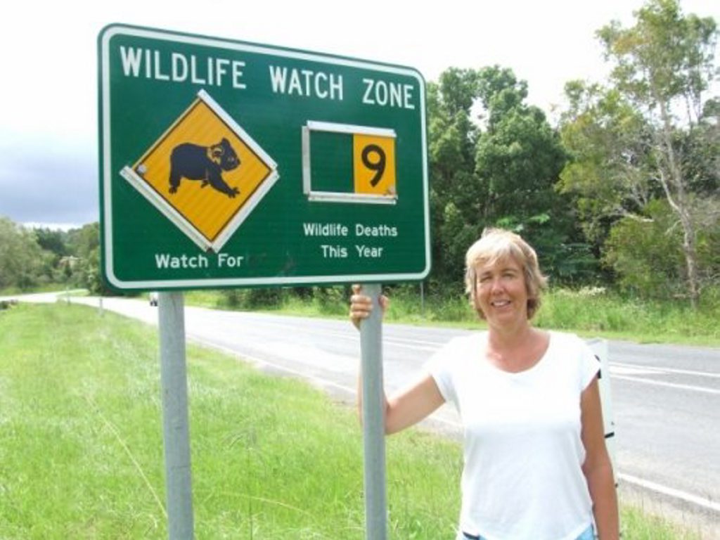 Jane Wickers with the Leftbank Road wildlife sign. Photo Contributed Jane Wickers with the Leftbank Road wildlife sign. Photo Contributed