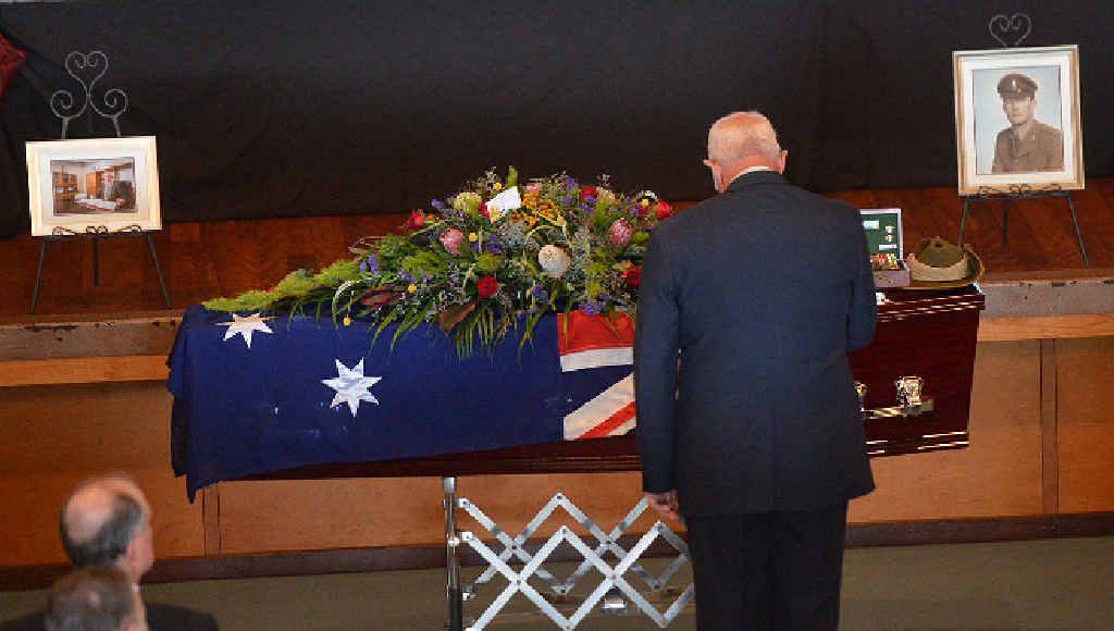 COMRADESHIP: Vietnam veteran Ivan Friske pays tribute to his fellow veteran as he places a wreath on the casket of former Gympie Region mayor Ron Dyne. COMRADESHIP: Vietnam veteran Ivan Friske pays tribute to his fellow veteran as he places a wreath on the casket of former Gympie Region mayor Ron Dyne.