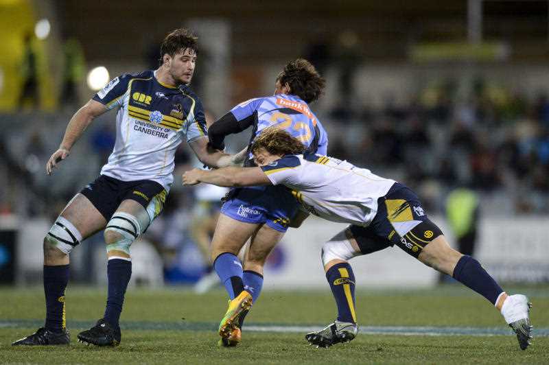 Sias Ebersohn of the Force (centre) is tackled by JP Smith of the Brumbies during the Round 19 Super Ruby match between the Brumbies and the Western Force at Canberra Stadium in Canberra, Friday, July 11, 2014. Sias Ebersohn of the Force (centre) is tackled by JP Smith of the Brumbies during the Round 19 Super Ruby match between the Brumbies and the Western Force at Canberra Stadium in Canberra, Friday, July 11, 2014.