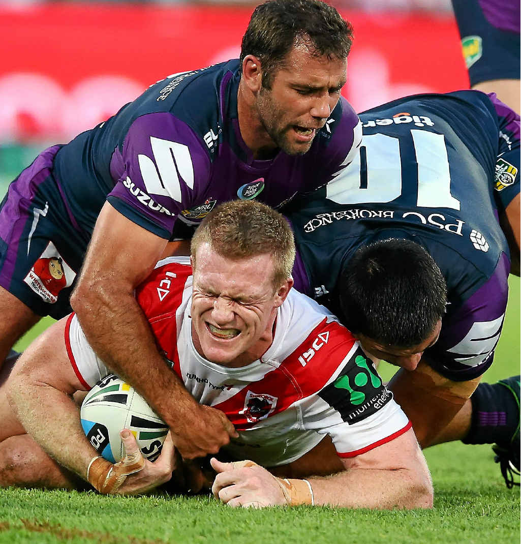 HOLDING ON: Cameron Smith and Jordan McLean of the Storm tackle Ben Creagh of the Dragons at WIN Jubilee Stadium in Sydney last night. HOLDING ON: Cameron Smith and Jordan McLean of the Storm tackle Ben Creagh of the Dragons at WIN Jubilee Stadium in Sydney last night.