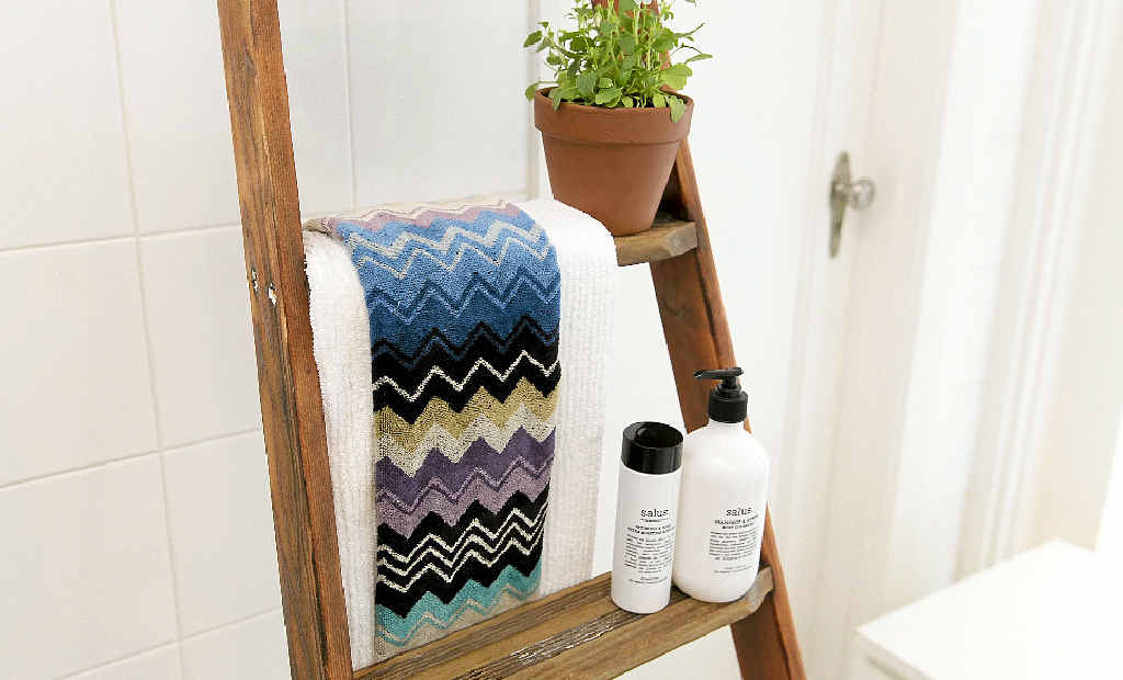 An old ladder finds new life as a charming bathroom addition. An old ladder finds new life as a charming bathroom addition.