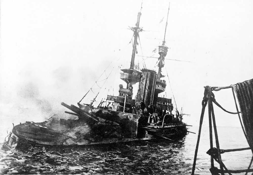 British battleship HMS Irresistible abandoned and sinking after striking a minefield the navy did not know existed. British battleship HMS Irresistible abandoned and sinking after striking a minefield the navy did not know existed.