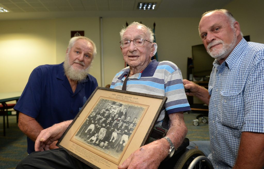Image for sale: L-R Greg, Stan and Bruce Shuker with a photograph of the Park Avenue Soccer Team taken at the end of the 1938-39 season which was recently discovered at a garage sale. Photo: Chris Ison / The Morning Bulletin