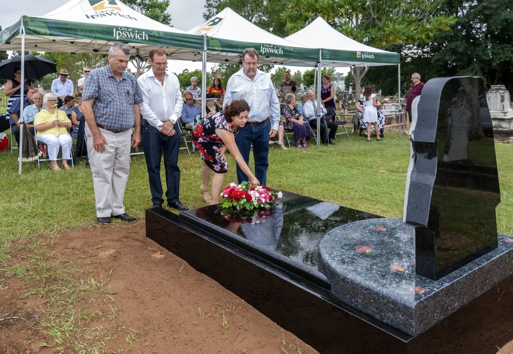 Councillor David Pahlke, Mayor Paul Pisasale and Councillor Paul Tully look on as Member for Ipswich Jennifer Howard places a flower on the grave. Councillor David Pahlke, Mayor Paul Pisasale and Councillor Paul Tully look on as Member for Ipswich Jennifer Howard places a flower on the grave.