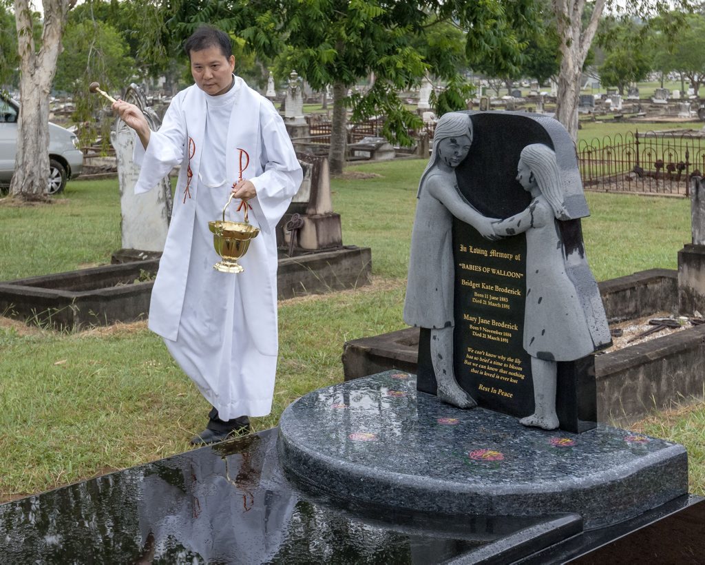 Father Neville Yun from St Mary's Catholic church does the blessing. Father Neville Yun from St Mary's Catholic church does the blessing.