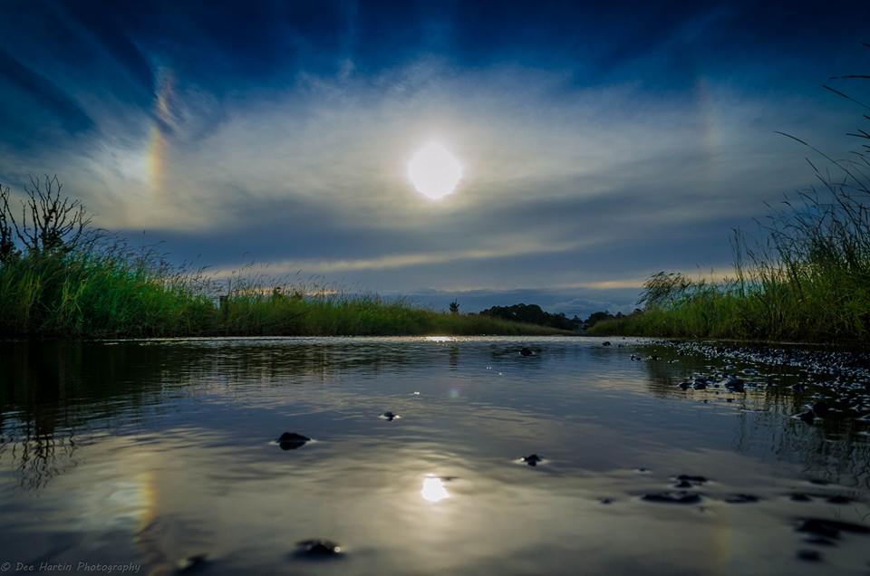 A halo around the sun and reflecting in the floodwaters across a dirt road at Casino. A halo around the sun and reflecting in the floodwaters across a dirt road at Casino.
