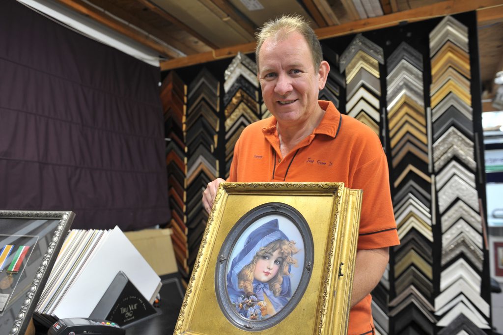 FRAMED: Trevor Yates from Just Frame It has again won an international competition recognising his gift as a professional framer. He holds the winning piece, a tribute to a girl who passed away in the 1900s. FRAMED: Trevor Yates from Just Frame It has again won an international competition recognising his gift as a professional framer. He holds the winning piece, a tribute to a girl who passed away in the 1900s.