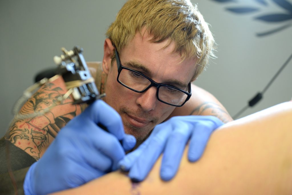 Tattoo artist Chris Neal working at Ink City Tattoo. Photo Allan Reinikka / The Morning Bulletin Tattoo artist Chris Neal working at Ink City Tattoo. Photo Allan Reinikka / The Morning Bulletin