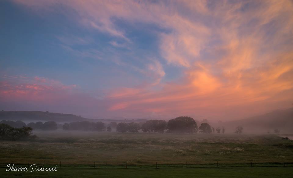 A beautiful start to the morning at Corndale Valley with low lying fog in the valley and a vibrant sky. A beautiful start to the morning at Corndale Valley with low lying fog in the valley and a vibrant sky.