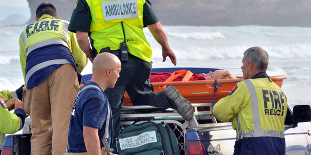 Emergency services load a boy onto the back of a four wheel drive vehicle after he was injured in a light plane that flipped while making a forced landing on Tomahawk Beach. Emergency services load a boy onto the back of a four wheel drive vehicle after he was injured in a light plane that flipped while making a forced landing on Tomahawk Beach.