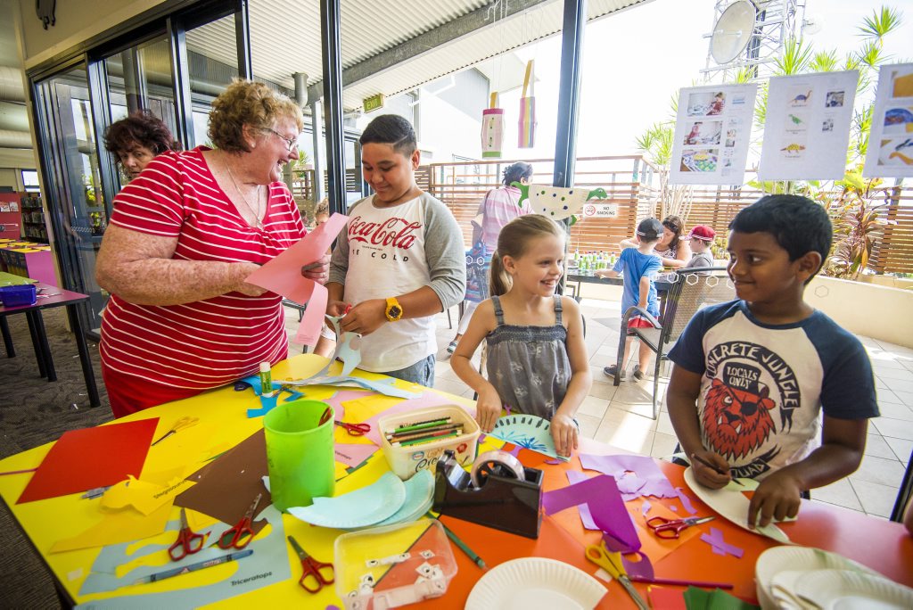 Rose May with youth, Malachi Tuakura, 9, Jessica Johansen, 8 and Nirupam Peetha, 7 at the Gladstone City Library school holiday activity yesterday.