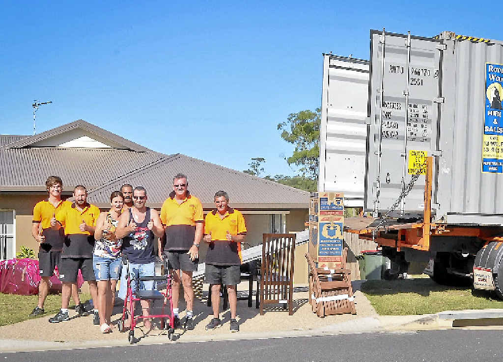 CHARITY AT HOME: Jamie and Todd Bartrum with Allied Pickfords Gladstone owner Tim Curran and employees, who helped move everything from the house for free. CHARITY AT HOME: Jamie and Todd Bartrum with Allied Pickfords Gladstone owner Tim Curran and employees, who helped move everything from the house for free.