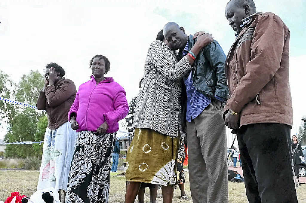 Mourners pray at a makeshift shrine at the scene where a vehicle is submerged in Lake Gladman. Mourners pray at a makeshift shrine at the scene where a vehicle is submerged in Lake Gladman.