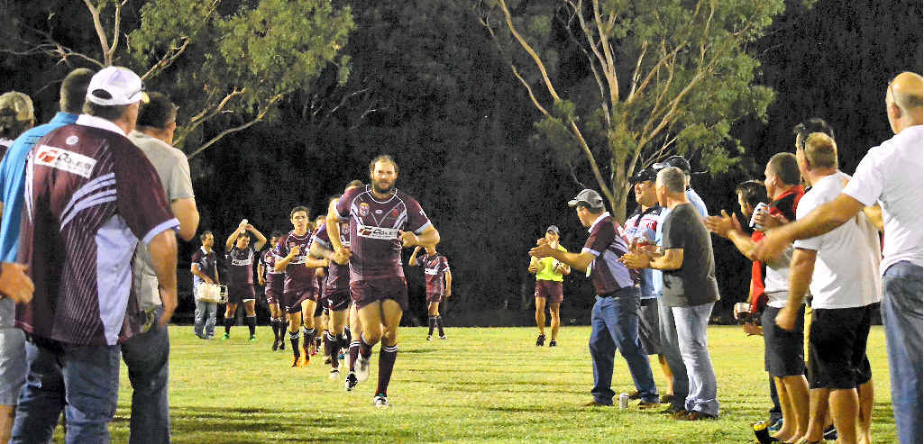 INSPIRATION: Isis Devils captain Peter Grant leads his side out, flanked by former Isis players, before the clash against Hervey Bay Seagulls at Childers Showground last month. INSPIRATION: Isis Devils captain Peter Grant leads his side out, flanked by former Isis players, before the clash against Hervey Bay Seagulls at Childers Showground last month.