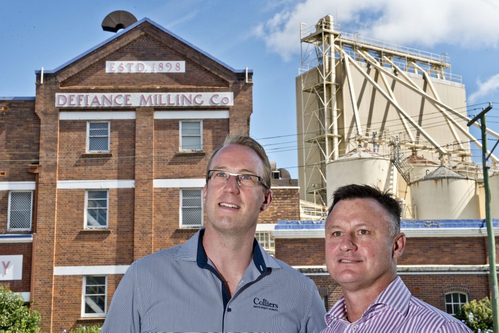 Colliers International Toowoomba commercial sales and leasing agents Justin Reisinger and Drew Camm celebrate the sale of the Allied Mills site in Toowoomba.